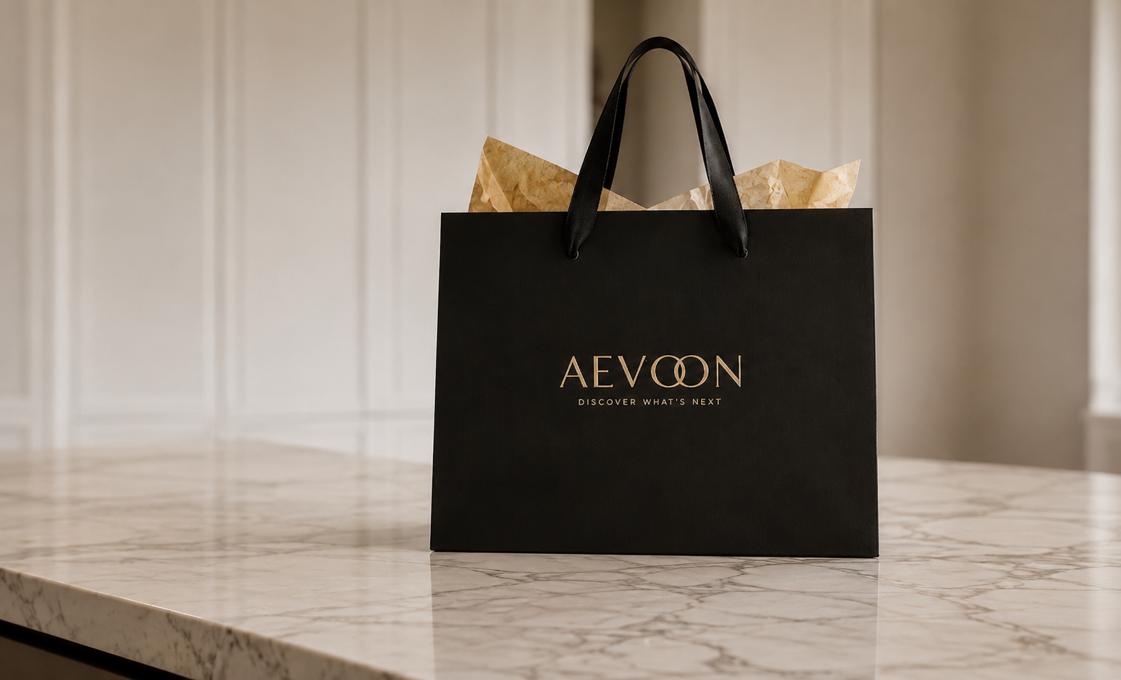 A black Aevoon shopping bag with gold lettering sits on a light marble countertop in a softly lit interior setting.